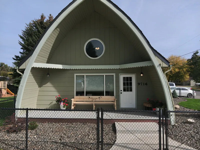 The front of Pickin&rsquo; Daisies Preschool in Hayden, a green A-frame building behind a fenced yard