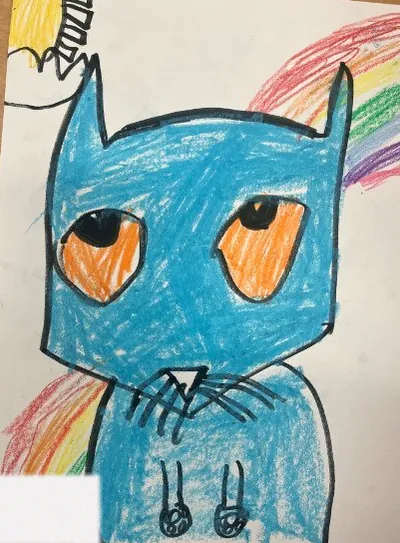 Child&rsquo;s crayon drawing of a blue cat in front of a rainbow