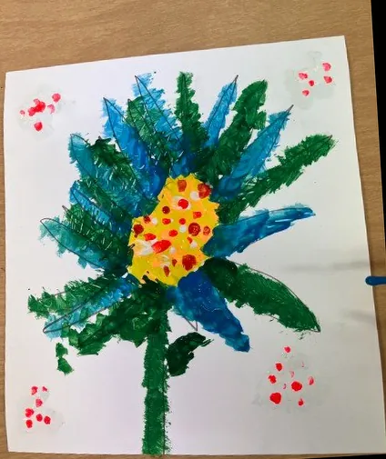 Child&rsquo;s painting of a blue and green flower with a yellow center