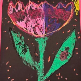 Child&rsquo;s oil pastel tulip on black paper