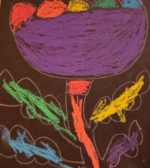 Child&rsquo;s oil pastel flower on black paper